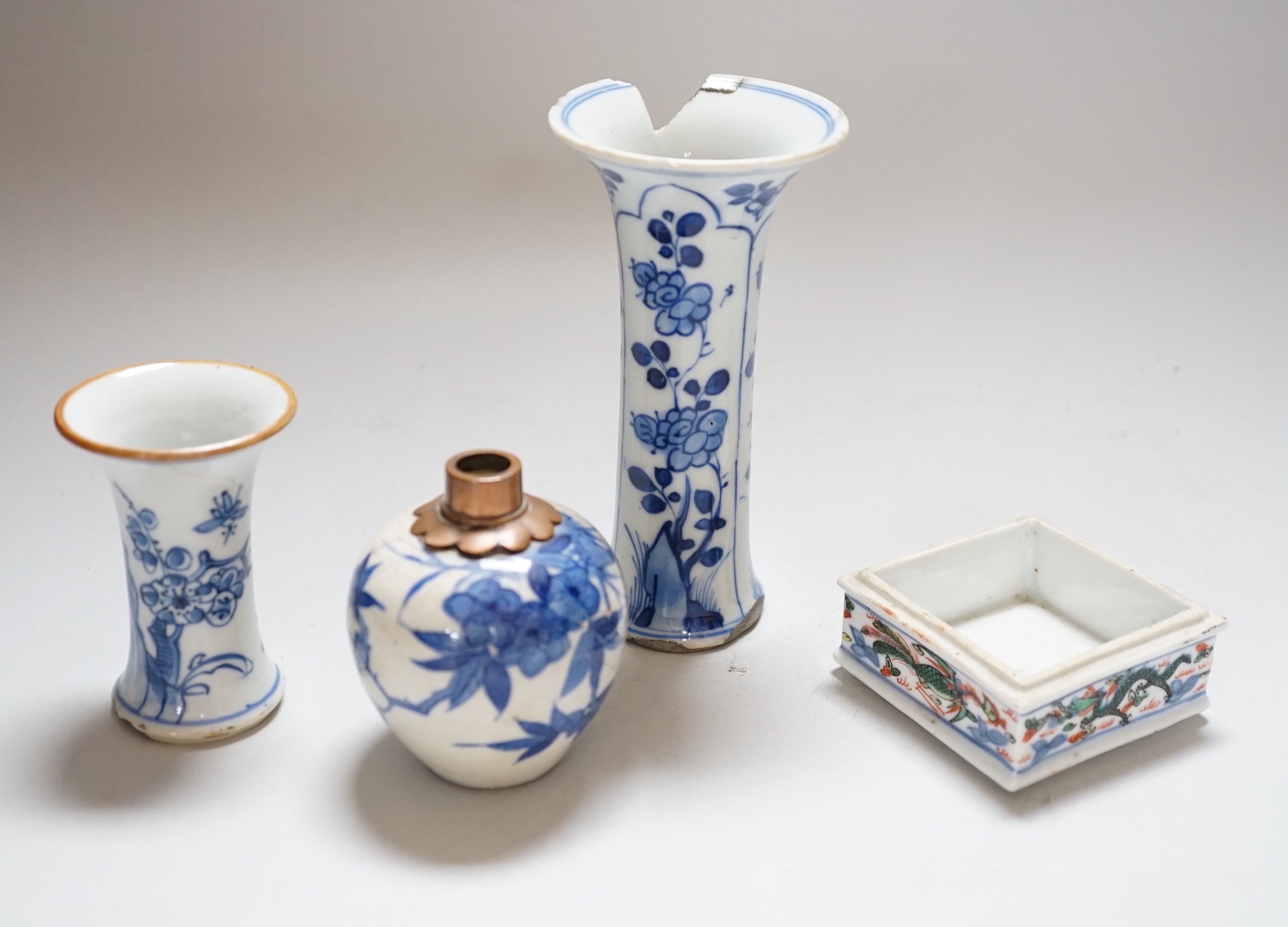 Three Chinese blue and white vases and a wucai square box, one with inscription, 18th century and later, tallest 14cm high